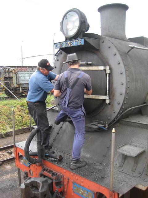 Tony and Nathan strain to close the smokebox door tight. If it's loose the loco doesn't steam so well