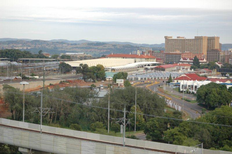 The complex railway layout of Pretoria main station, with the Gautrain development, can be clearly seen here. The construction work on the right is the Gautrain terminal for the Johannesburg and Hatfield sections. The former NZASM shed has been incorporated into the terminal station and the passenger parking area has been extensively developed. Gone is the former carriage shunting yard of Platform 1