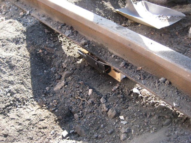 Close up of the apparatus in place under the track before being buried