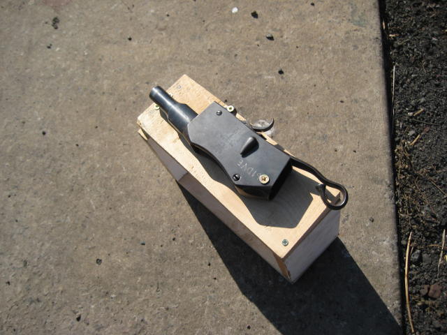 The truncated rifle on its wooden frame