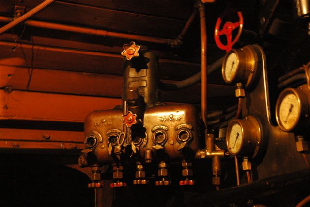 The lubricator takes on a beautiful hue, under the soft glow of the cab lights. The lubricators in mechanical stoker locomotives are fitted with an extra feed that will go down to the stoker motor