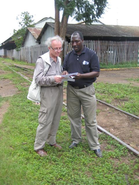 Geoff Warren, an old steam volunteer in Kenya, has come back from UK for a visit. Here he discusses timetables with Isaac.<br /><br />Photo by John Ashworth