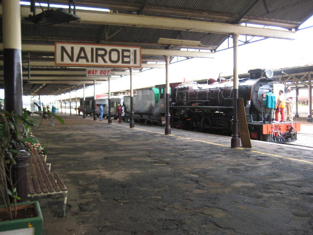 A steam train stands in Platform 1, with 3020 facing Uganda and the camera facing Mombasa