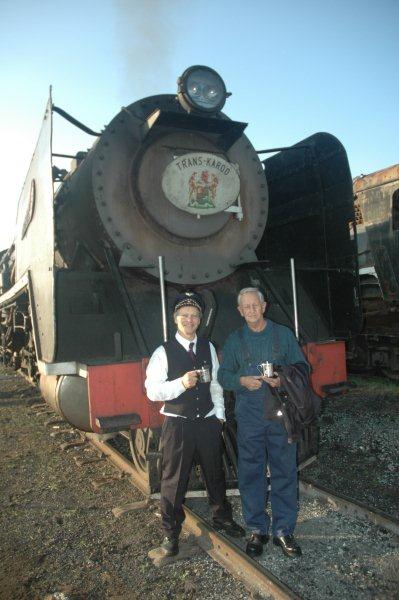 Prior to departure, the guard and driver pose in front of their locomotive for the day. 15F 3117 read to haul the Mothers Day train to Cullinan, with one of the name boards in Nathan's collection. The fancy outfit of Nathan's is a Swedish Conductor's, sent to him by FOTR member, Goran Enqvist, himself a driver on the SJ.