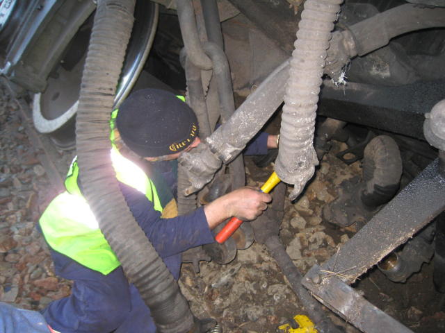 Nathan uncoupling some of the pipes and fittings between the loco and tender so they can be separated by the recovery crew