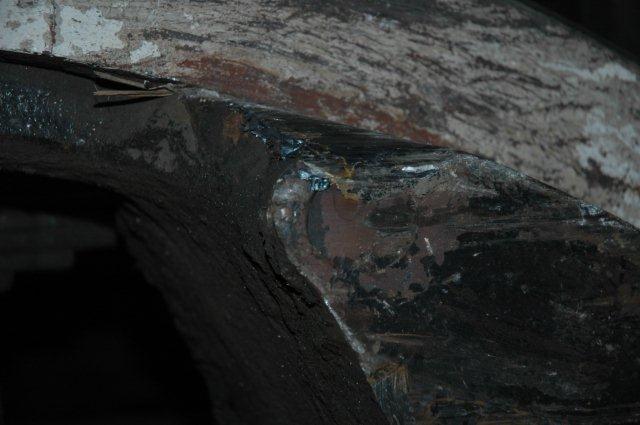 Close up of driving wheel counter weight showing damage.