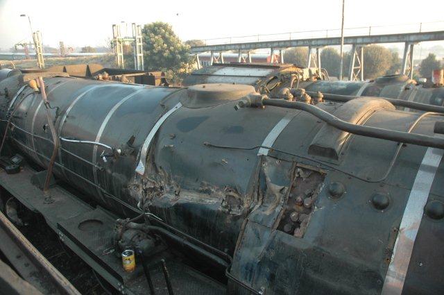 Fireman's side view of damage to boiler lagging and there is damage to a few of the flexible stays that can be seen at the open section of the lagging