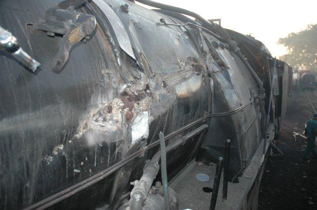 View from running board on fireman's side showing damage to regulator rod area. The rod had been removed at this stage.