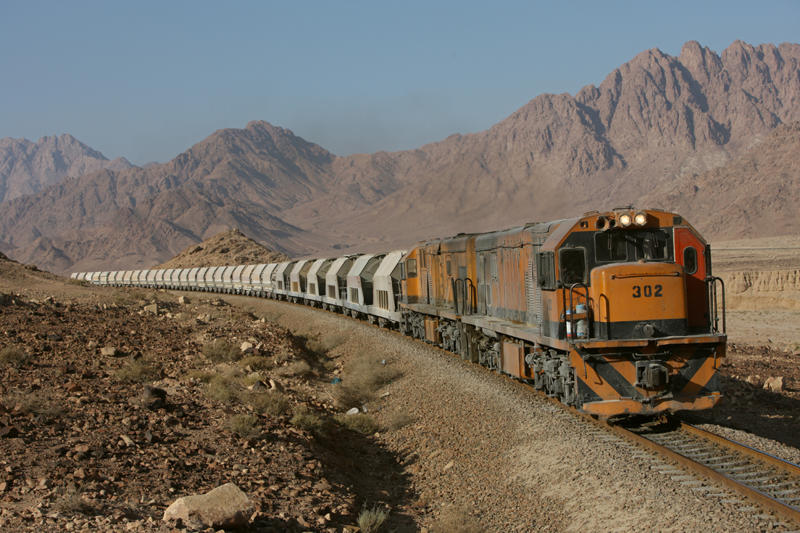 Aqaba Railways Corporation locos 302 and 306 work hard to climb the bank between Umran and Selmer on their way north to the Phosphate mine at Hisa on 25-10-2009