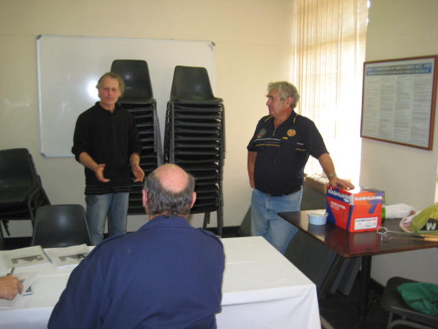 Nathan's speech goes on, while examiner Coen looks on
