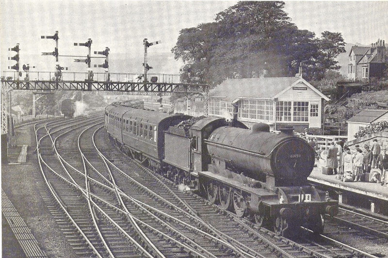 Falsgrave signalbox and gantry. By way of a comparison I have found the attached picture in a magazine taken at the same location 50 years ago of a B16 4-6-0 arriving from York!