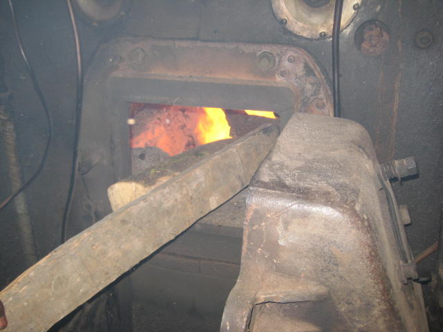 Firewood is piled into the firebox to help raise the steam pressure