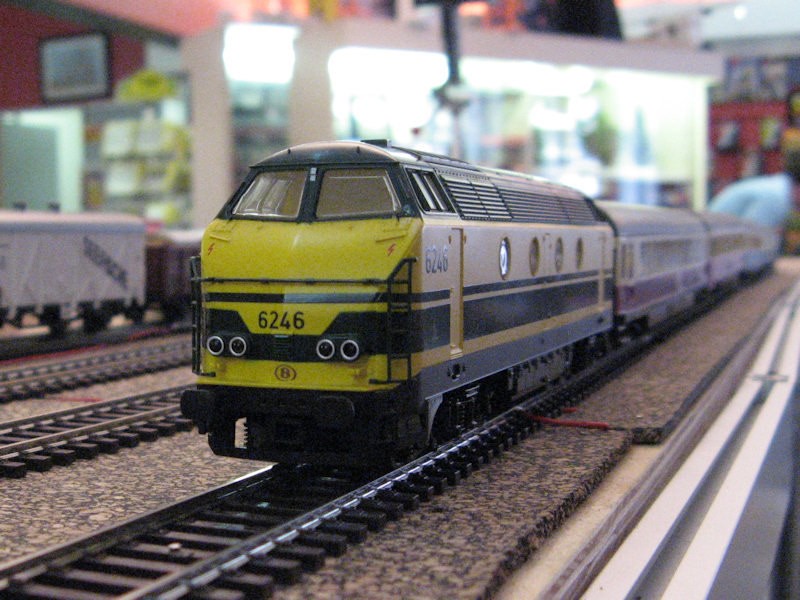 A German engine comes through the yard hauling a long rake.