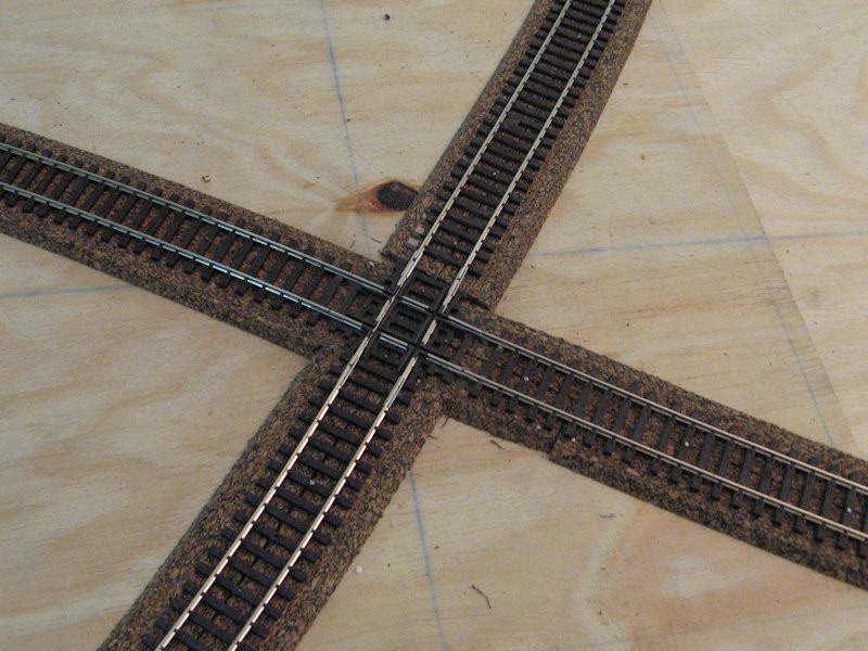 A unusual piece of track for a European layout - a crossover. But, it is hidden!<br /><br />The frogs on the crossover are plastic and were filed down to ensure smooth running of rolling stock with different wheel diameters and thicknesses (as per different manufacturers etc.).