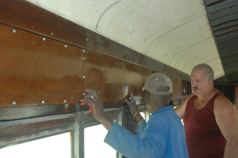 Pekenese and helper fit pre varnished panels in the coach.