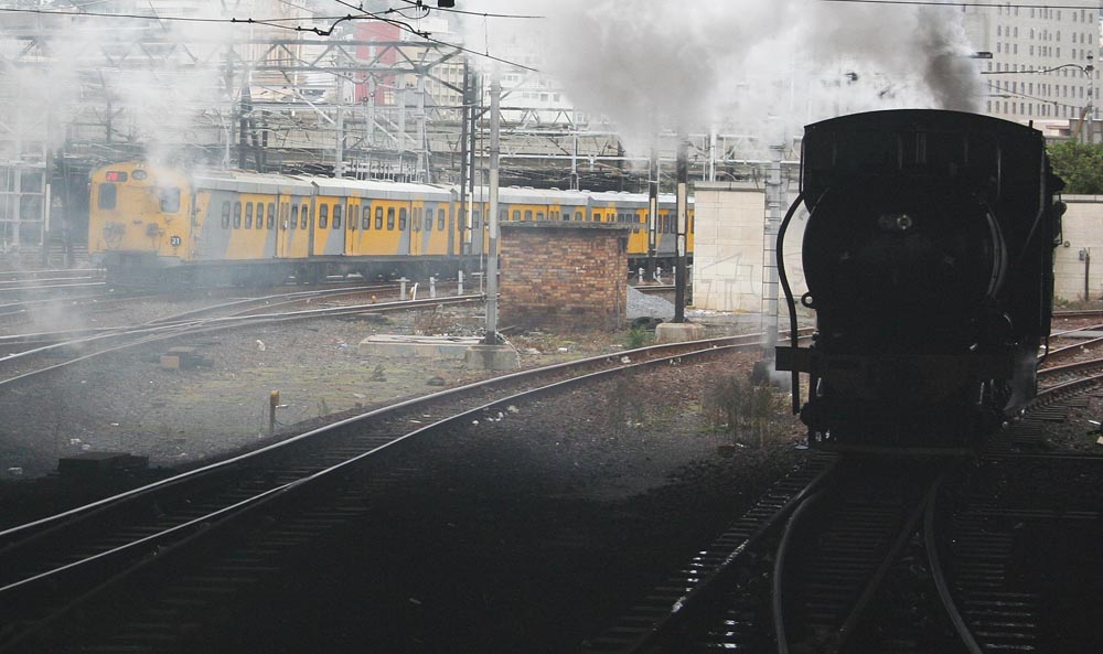 3655 going around to push the train into Monument station. A Metro leaves Cape Town for Bellville. Note no head light on