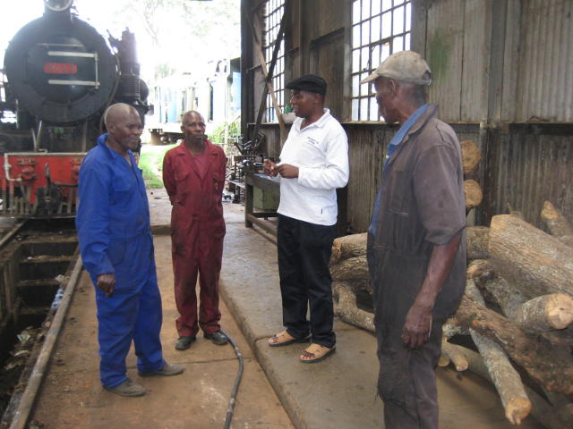 Nairobi Railway Museum Curator Maurice Barasa (in white) discusses progress with the boilermakers and fitters.