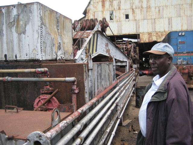 David Gitundu, a museum volunteer, stands by the wagon on which the jib rests