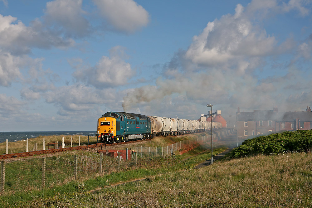 With the North Sea as a backdrop 55022 accelerates past the terrace cottages at North Blyth.