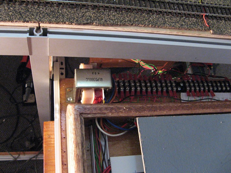 The wiring running into the back of the panel. The square item upper left is one of the transformers for the controls. The cover has been moved to the right so the wiring inside can be shown.