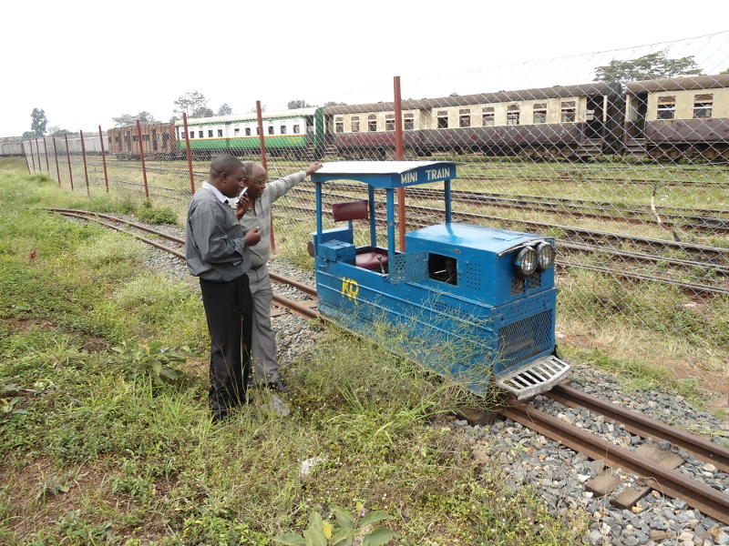 The two king-pins of steam operations in Kenya, Museum Curator Maurice Barasa (left) and businessman Frances Waweru, stand with the miniature loco.