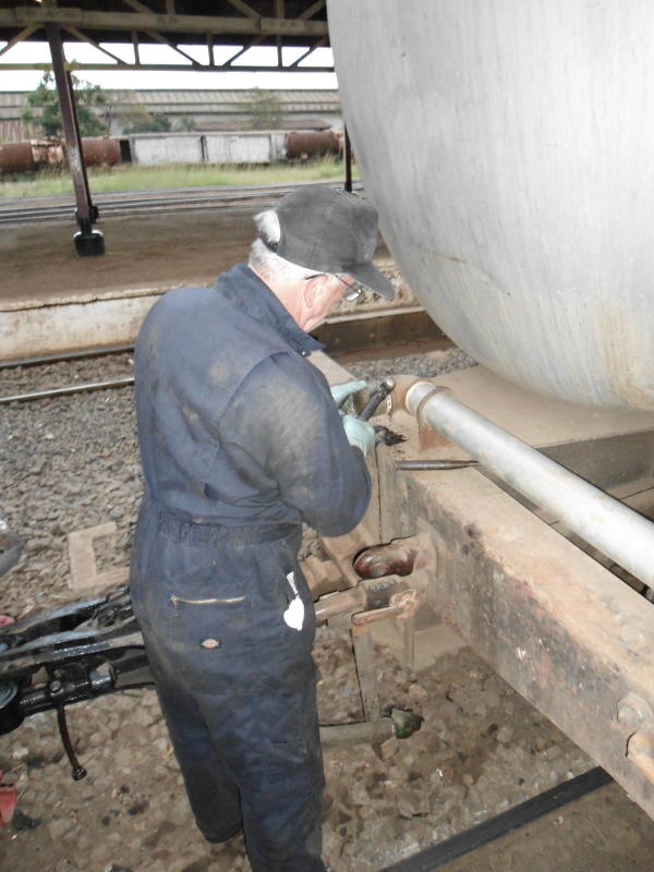 As usual we found we didn't have the right fittings for the water tank. Kevin uses the all-purpose hammer. Eventually we did find enough bits of pipe and odd metal fittings to pump water from the tank into the tender