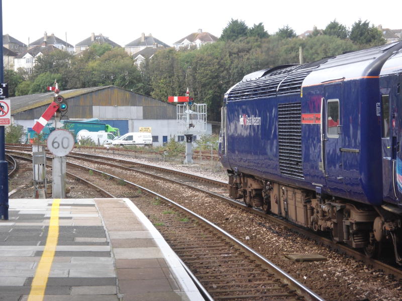 The Class 43 power unit on the rear of a London-bound HST stands in Truro Station, with semaphore signals in view.