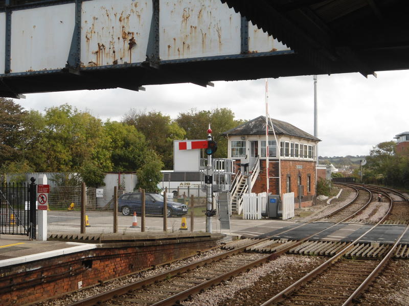 A semaphore signal, signal box and level crossing at the London end of Truro Station
