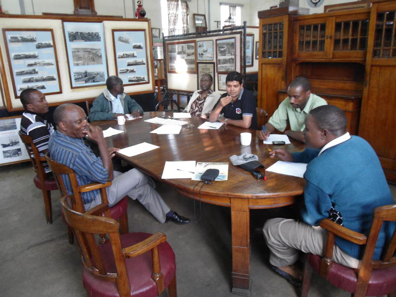 The members. Museum Curator Maurice Barasa sits at the head of the table with his back to the camera. Anti-clockwise, to his right, Julius (a diesel driver), Hanif (treasurer), Gibson, David, Samuel, Francis Waweru, and the empty seat of yours truly