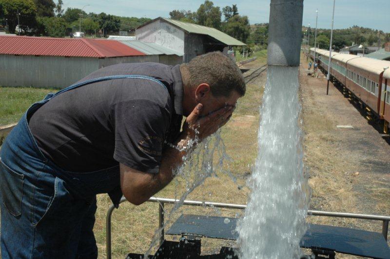 Hot work on a steam locomotive. Gabor gets a wash.