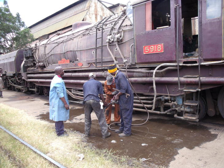 Connecting up the armoured steam hose to bring steam from the stationary boiler to 5918. A while ago there was a discussion on the East_African_Steam Yahoo group as to whether this is dangerous, but in fact it is the preferred method of firing up an oil burning loco in Kenya