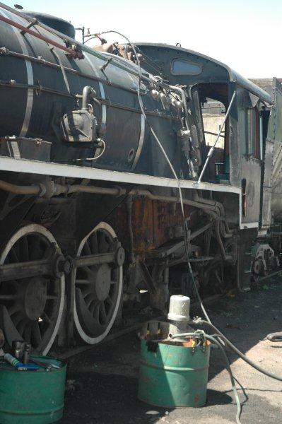 The set up for the boiler hydraulic testing. There is an air operated pump situated in the water-filled drum. A pipe leads from the pump up to a controlled valve on top of the boiler where a washout plug is situated. The water will be pumped into the already-filled boiler, to bring the pressure up to the required mark on the pressure guage.