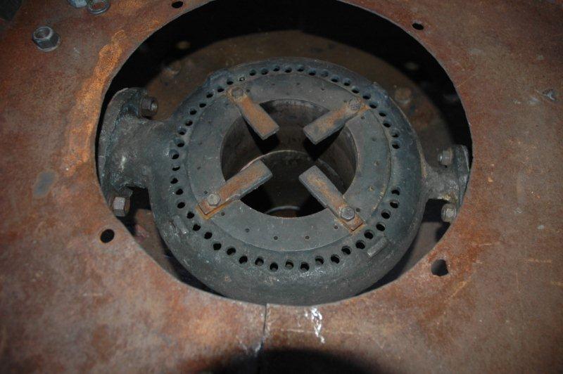 The base of the Table Plate, which supports some of the Spark Arrestors and assist with the drafting of the exhaust steam in the smokebox, can be seen and in the "hole" lies the blast pipe cap showing the Goodfellow Tips. Still to be fitted will be a conical spark arrestor to close the gap between the blast pipe cap and the table plate deflector. Finally the spark arrestors will be fitted and the smokebox is complete