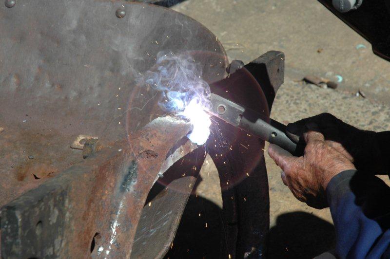 John welds the firebox fire door frame.