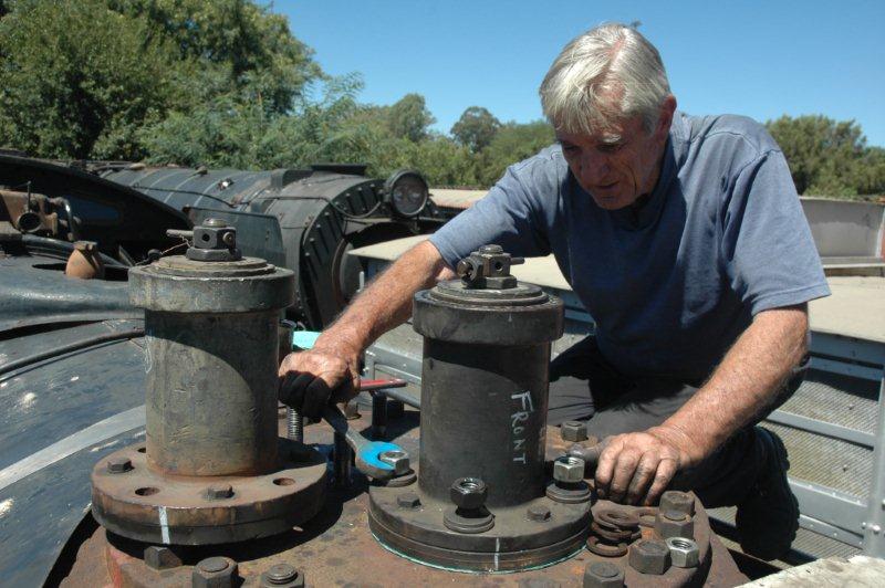 John tightens up, while the rear safety valve awaits fitting. A hot task in the open under sunny skies. Blessed art thou who have a shed!