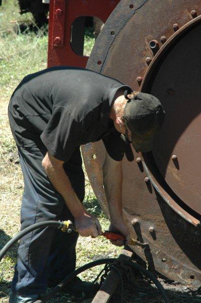 Spikkels at work with the air powered chipping hammer to descale the smoke box faceplate of the 19D.