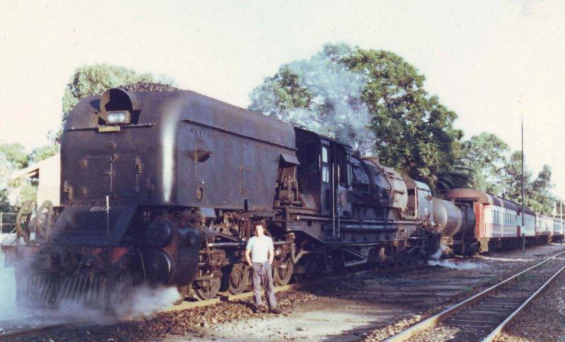 Whilst the railways of Rhodesia were having a motive power shortage, many class GMAM were sent up there for a while. After returning from Bulawayo to Capital Park, they were put into service on construction trains and with a bit of a push, were placed on the Cullinan line. Seen here before the 06:15 departure is GMAM 4061 and the Fireman Nathan with his wife's name &quot;LINDIE&quot; on the bunker. Only this side of the loco was cleaned for the photographers, otherwise these locomotives were dirty. 1981