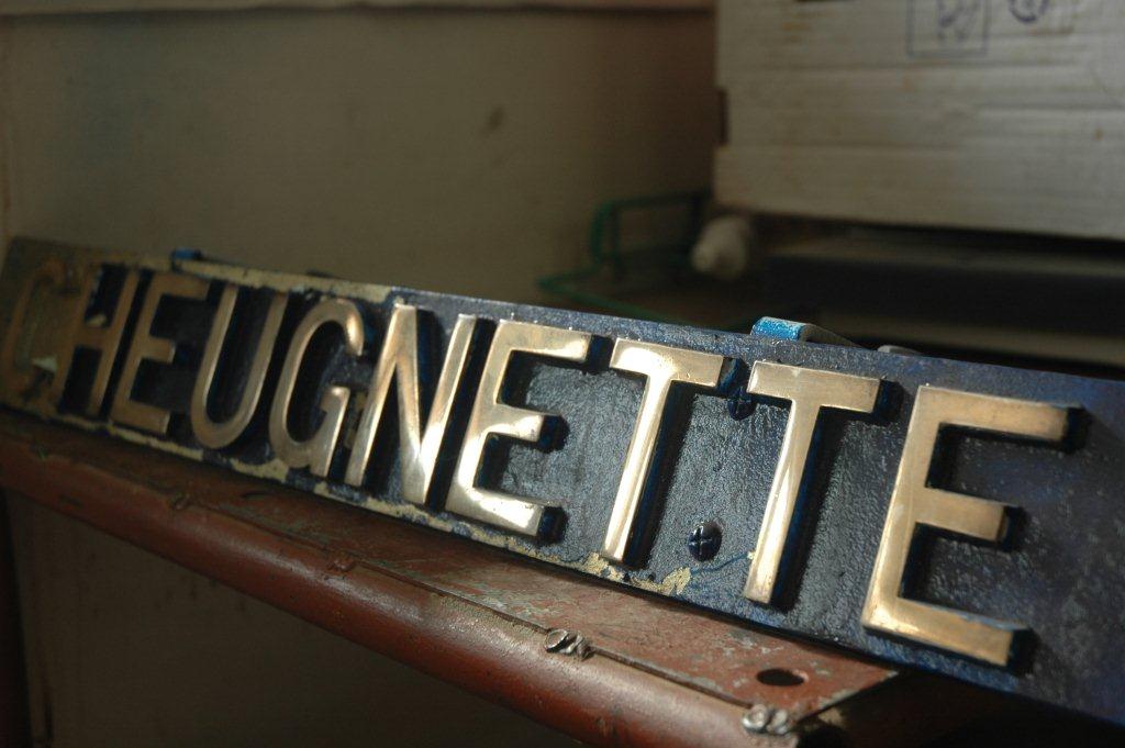The nameplate, pronounced "CHENAY", has all the old paint cleaned off.