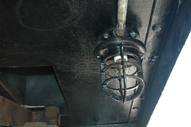 Underfloor lighting fitted on 3117 near the valve gear will enable the driver to do some early morning greasing and oiling. Robert Dadford and his assistant Louie have been hard at work fitting the electrics on this loco, additional to the original specifications. <br /><br />Photo by Nathan Berelowitz 09/02/08