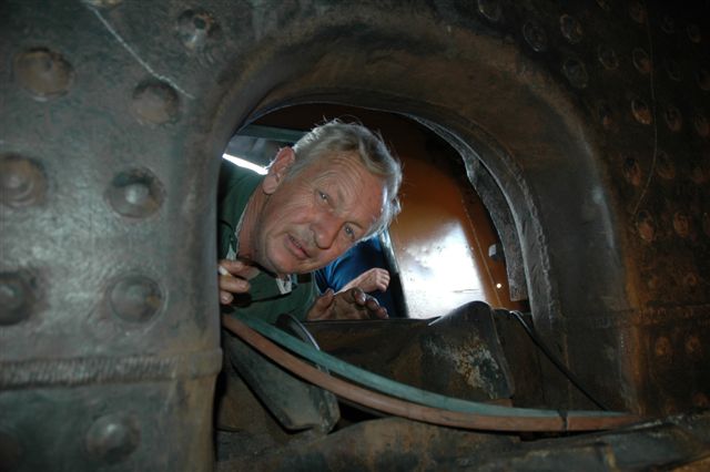 Ever curious Cliff Petzer, looks into the firebox to add comment to the work in progress.