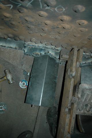 Protective plating fitted over the hand shaker pull rod tunnels, to prevent live coals, when cleaning fire, from falling on and distorting the rods over a long period of time. The coals will now fall away into the ashpan. The rear section is the sealing up of the ashpan to prevent live coals from<br />falling out and causing lineside fires. The view here is at the cab end and looking downwards.