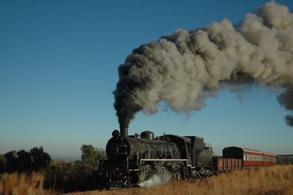 Crisp clear winter skies and a beautiful white trail of loco exhaust heralds the approach of the class 24 on a mixed from Cullinan