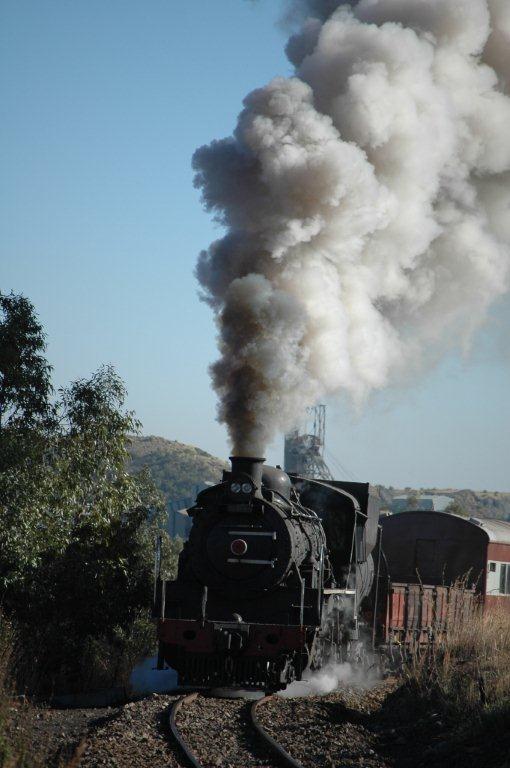 The Premier mine headgear in the background looks on as the 24 hauls its load up the grades out of Cullinan as timeless trains before it. Hard to believe the world's largest diamond was found at this village