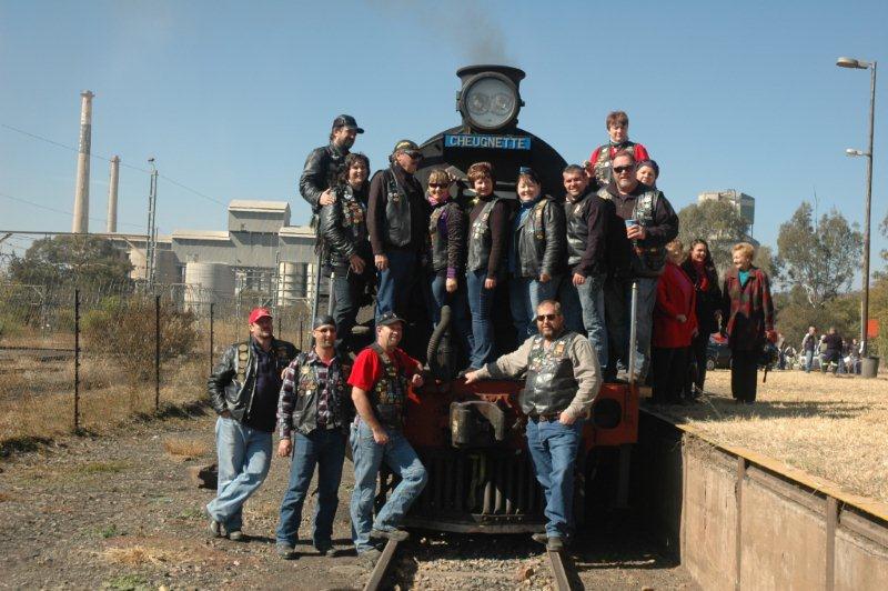 Members of the motorcycle group pose for a picture.