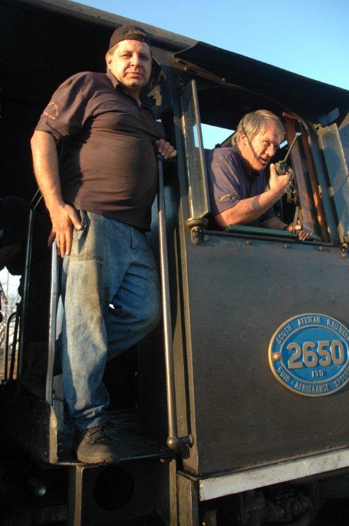 Having just passed out as steam train drivers, &quot;Drivers&quot; Gabor Kovacs and Tony Attwell pose in the cab of 2650 after returning with a charter from Cullinan