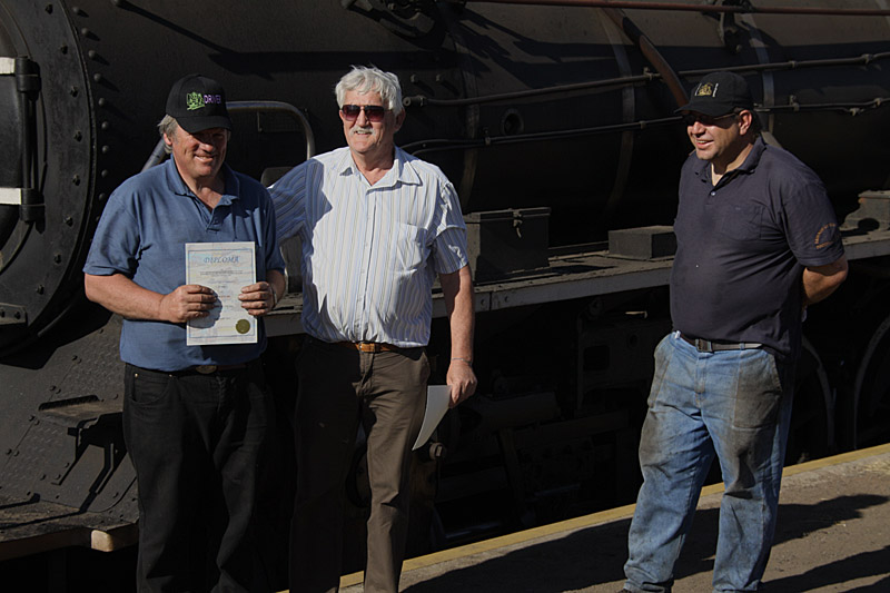 Instructor Cliff congratulates Tony while Gabor looks on