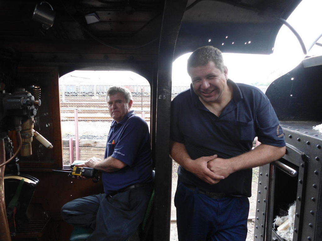 Trainee driver Steve sits while qualified driver Gabor looks on