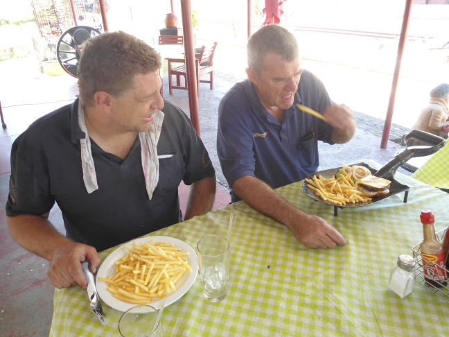 Feeding time at the zoo. Gabor and Steve have lunch at Cullinan Station restaurant. Note the food served on a cut-down shovel.