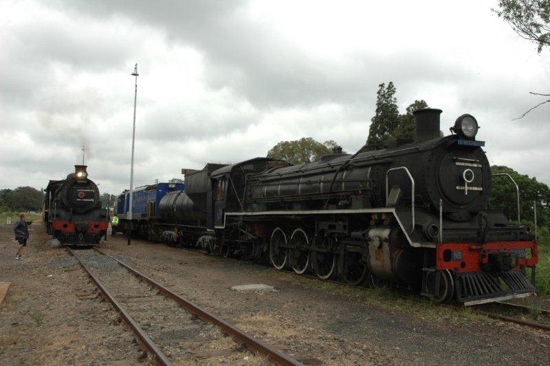 The class 24 has arrived at Cullinan and the passengers are off, while the 19D, with rods removed and work ongoing on the other side to replace tender bearings, waits with its hauler, the 34 class diesel, to take her back to Capital Park after the derailment due to sleeper theft on the same spot as the 2010 derailment.