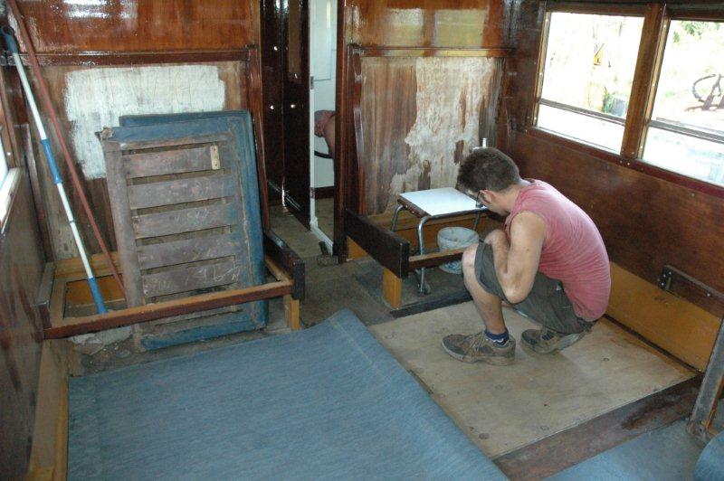 The opposite side of the coach gets the new linoleum cover over the new floorboards.